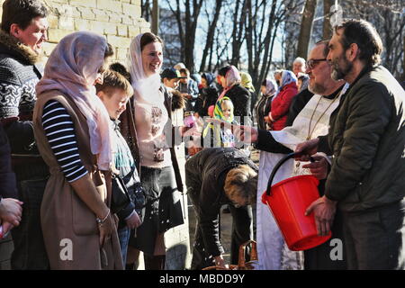 Orthodox priest does water blessing during Easter celebration in Kiev church Stock Photo