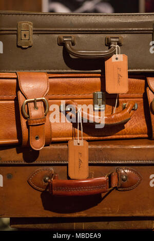 stack of brown leather suitcases used in the set design of a theatrical show Stock Photo