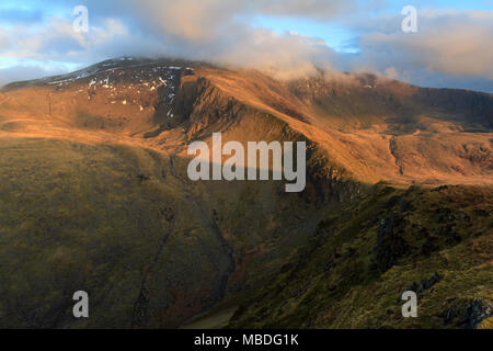 Summit of Snowdon in late evening light from the summit of Moel Cynghorion Stock Photo