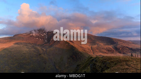 Summit of Snowdon in late evening light from the summit of Moel Cynghorion Stock Photo
