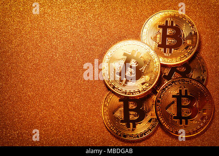Bitcoin over gold glitter background. Business concept Stock Photo