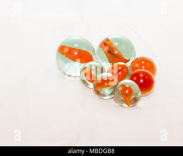 close up of two sizes of orange cats-eye marbles Stock Photo