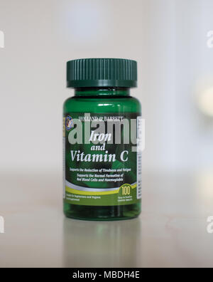 Vitamin C & Iron supplements in a clear bottle full of little tablets to make you feel better Stock Photo