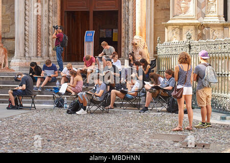 Architecture students drawing architectural details during en plein air assignment near Basilica of Santa Maria Maggiore in historical Upper Town Stock Photo