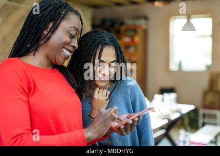 Mother and daughter using smart phone Stock Photo