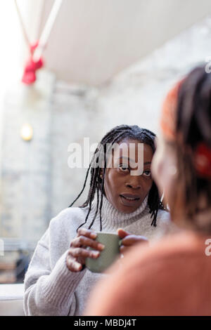 Women friends talking and drinking coffee Stock Photo