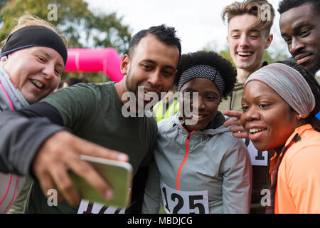 Friend runners taking selfie at charity run Stock Photo