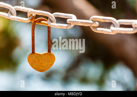 Heart shape lock on rusty chain Stock Photo