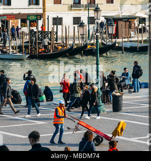 Luggage porters advertising their services in front of Venice's Santa Lucia railway station Stock Photo