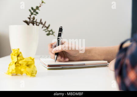 Creative writing concept with notebook and crumpled paper balls. Editing and copywriting workplace. Stock Photo