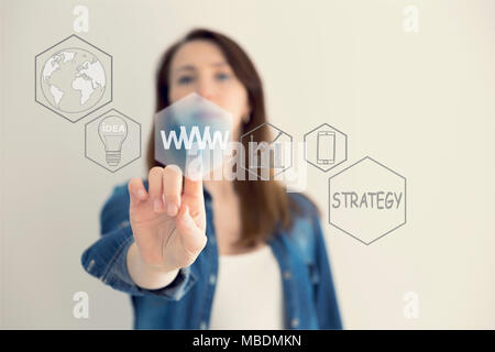 WWW concept with hand pressing a button on blurred abstract background. The abstract image of the hand point to the business virtual hologram. Future  Stock Photo