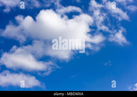 Blue sky with whispy fluffy cumulus clouds Stock Photo