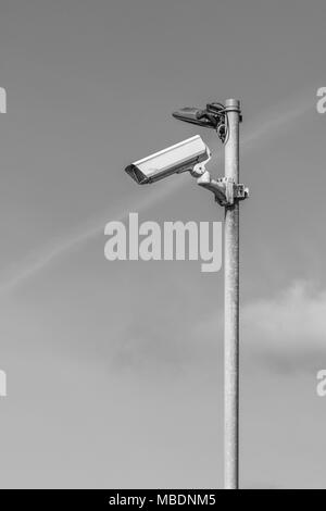Black and white monochrome of CCTV security camera - Watching over You, surveillance / Orwellian / Big Brother / intelligence gathering concepts. Stock Photo