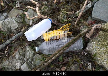plastic bottles washed up on the tide line, part of the growing plastic pollution problem. Stock Photo