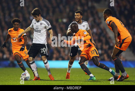 Fulham's Lucas Piazon (second left) holds off Reading's Omar Richards (left) during the Sky Bet Championship match at Craven Cottage, London. Stock Photo