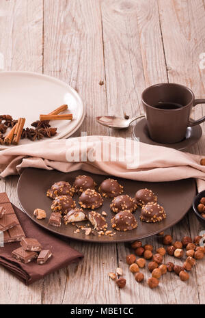 Closeup of squeezing filling of salted caramel cream from confectionery bag  into candy molds for preparing handmade chocolate pralines Stock Photo -  Alamy