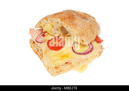 Ham and Emmental cheese toasted in ciabatta bread with tomato and red onion isolated against white Stock Photo