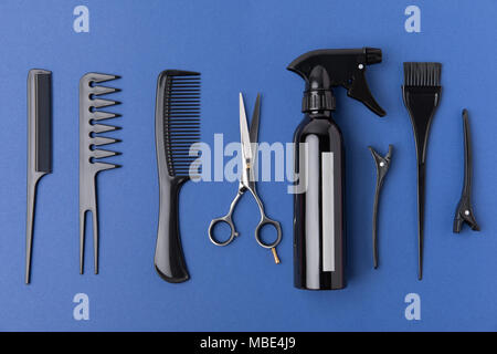 flat lay with black hairdressing equipment, isolated on blue Stock Photo