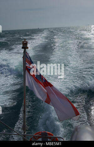 A British White Ensign flying from the back of Royal Navy P2000 HMS Dasher P280 Stock Photo