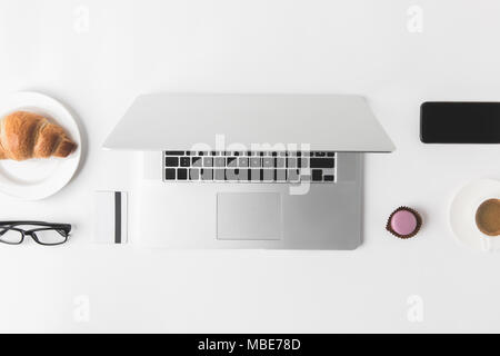 flat lay with digital devices and breakfast on white tabletop Stock Photo
