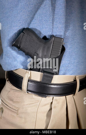 Man with gun tucked in pants isolated on white Stock Photo - Alamy