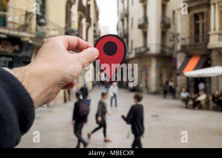 closeup of the hand of a young caucasian man with a red marker in the old town of an European city Stock Photo