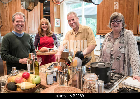 Two senior couples getting together for a dinner party. Stock Photo