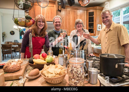 Two senior couples getting together for a dinner party. Stock Photo