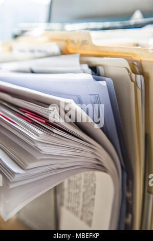 Close-up of files and file folders on a desk top in an office. Stock Photo