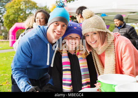 Portrait smiling, confident family at charity event in park Stock Photo