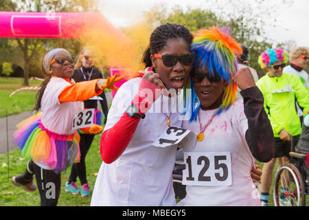 Portrait confident, enthusiastic female runners cheering at charity run in park Stock Photo