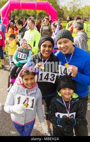 Portrait smiling family with medals at charity run Stock Photo