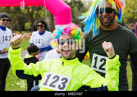 Portrait enthusiastic male runners wearing wigs at charity run Stock Photo