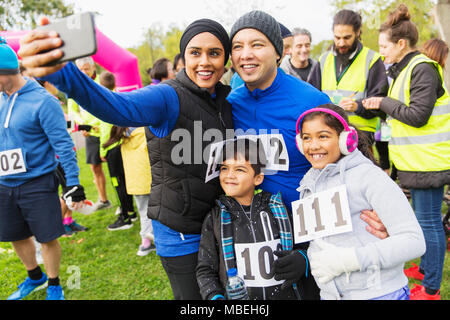 Family charity run runners taking selfie with camera phone Stock Photo