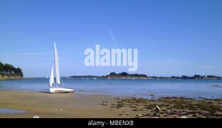 Sailboat stranded on a beach of Ile aux moines in Gulf of Morbihan, Brittany, France Stock Photo