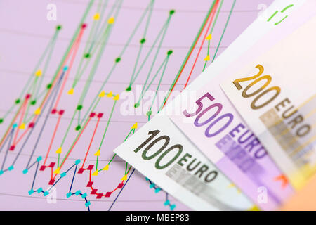 banknotes of European currency laying on chart of stock market Stock Photo