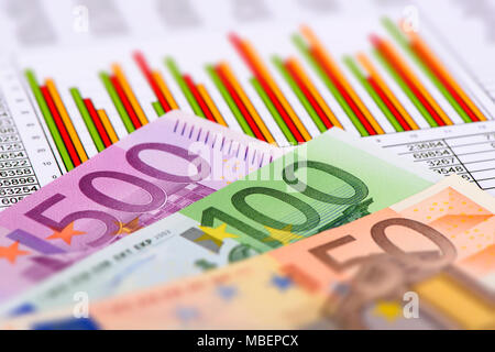 banknotes of European currency laying on chart of stock market Stock Photo