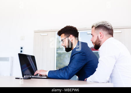 Young Business Colleagues Working On New Project On Laptop Stock Photo