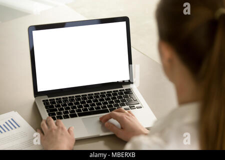 Businesswoman in office working on laptop with mockup blank screen. Empty copy space on monitor for business advertisement, corporate website, company Stock Photo