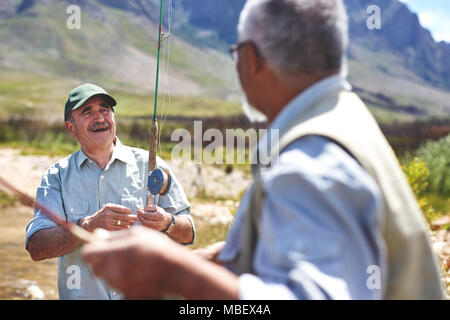 Man holding fishing pole over hi-res stock photography and images