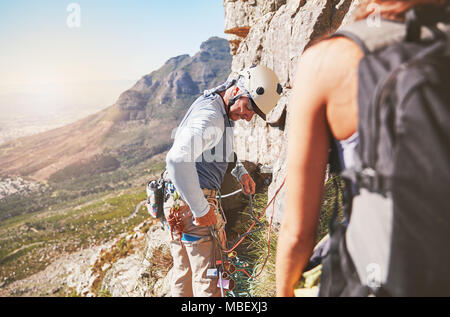 Male rock climber checking equipment Stock Photo