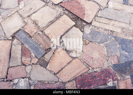 Close-up part of stone sidewalk from stones of different forms and sizes. Stock Photo