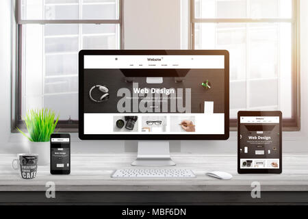 Modern responsive flat web site design presentation on computer, tablet and smart phone display. Office desk. Window and sun light in background. Stock Photo