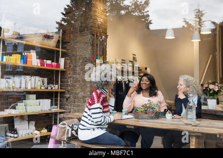 Women friends drinking tea at cafe shop Stock Photo