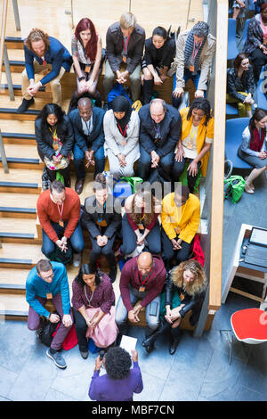 Overhead view conference audience listening to speaker Stock Photo