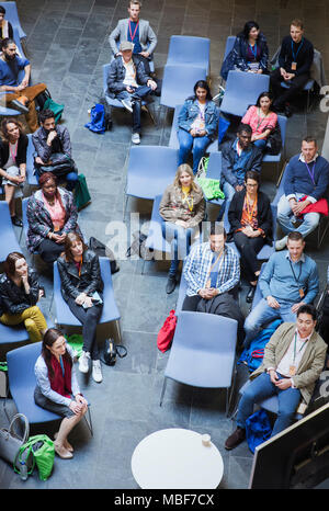 Overhead view audience watching video conference Stock Photo