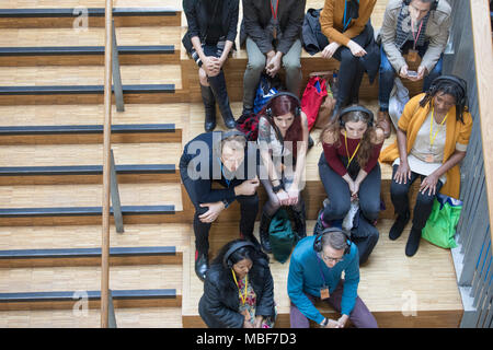 Overhead view conference audience listening with headphones Stock Photo
