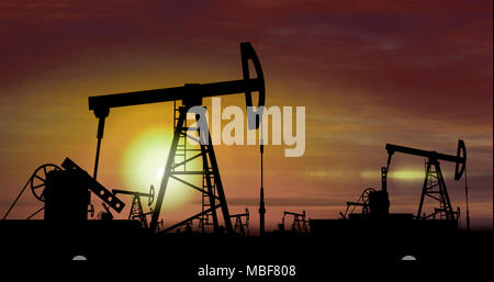 Oil pumps silhouettes working on clouds and sun in background. Pumpjack on oilfield on sunset. Concept of oil rig, global warming, environment polluti Stock Photo