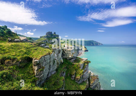 Hiker resting on a headland in the Valley of the Rocks on South West coast path, Devon, England, UK Stock Photo