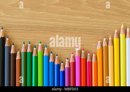 Colorful pencils isolated on wooden background, copy space Stock Photo